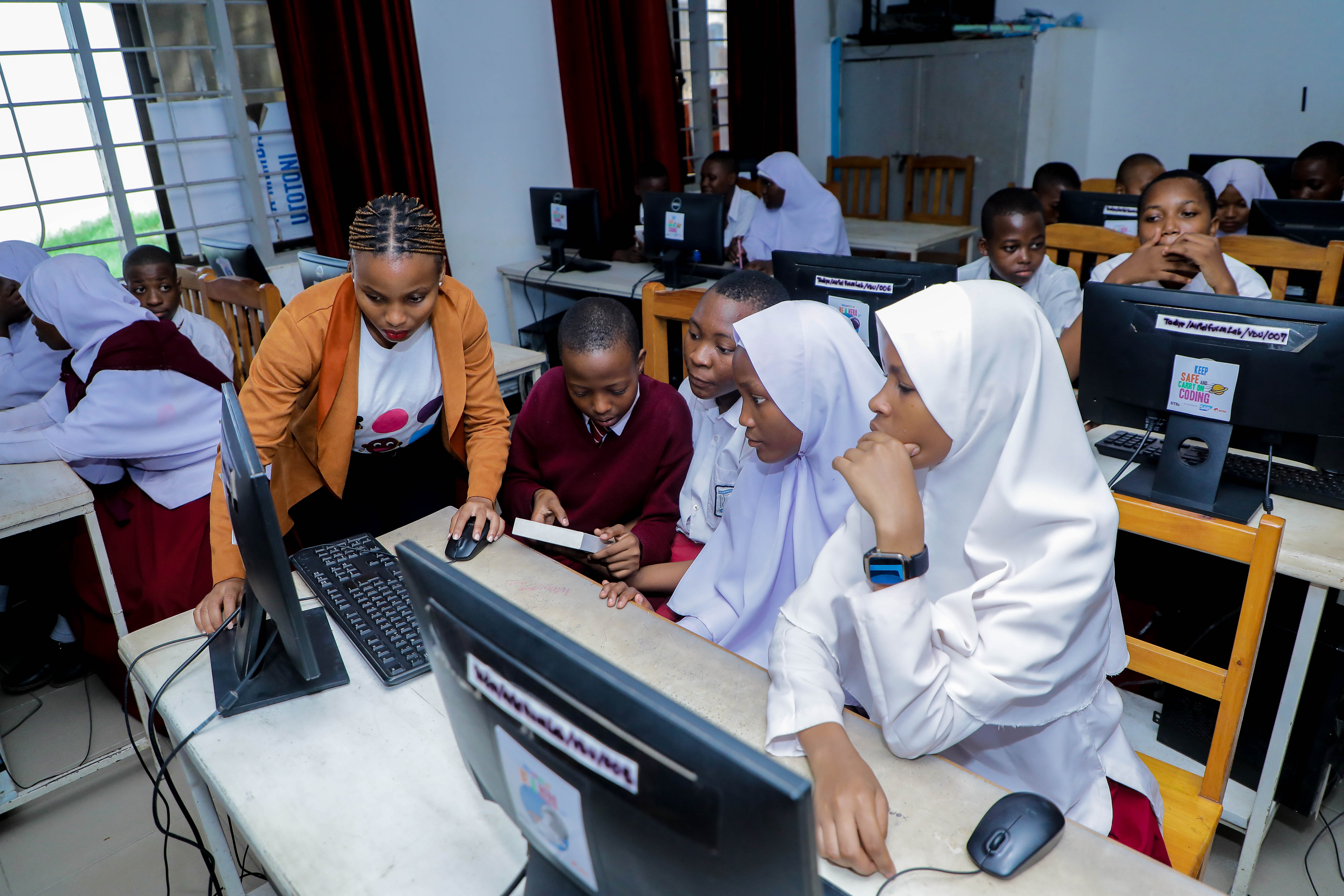 Students learning digital skills with a Tai facilitator